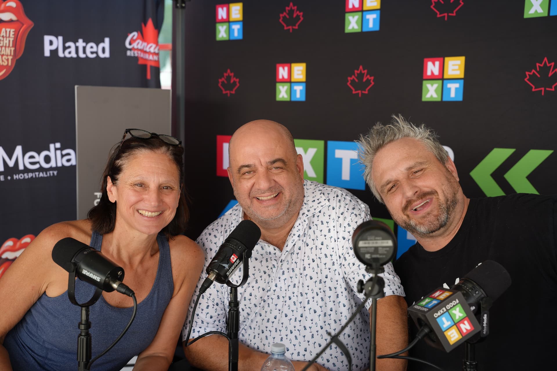 Podcast guests and hosts on mic at the NEXT Food Expo booth