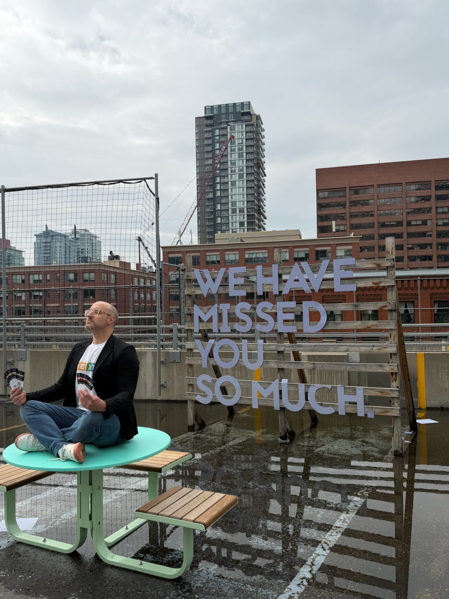 Rooftop content capture with 'We have missed you so much' sign